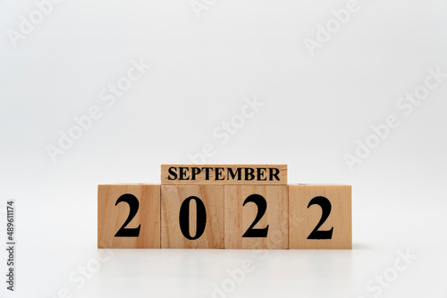 September 2022 written on wooden blocks isolated on white background with copy space