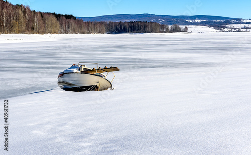  A boat on a frozen lake. Frozen Lake Vlasina - vlasinsko jezeto in Winter photo