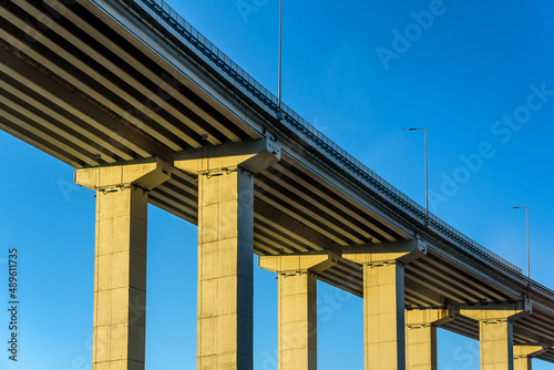 Highway Road bridge on columns with blue sky in the background. Straight road line with empty copy space. © Ivan