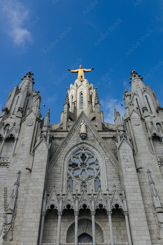 Christ statue on top of the Temple of the Sacred Heart of Jesus church on mount Tibidabo in Barcelona, Spain