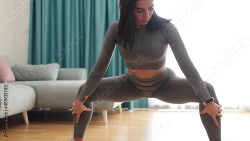 butt workout at home squats. Attractive Woman with strong butt workout at home. Female gymnastics. Glutes workout motivation.