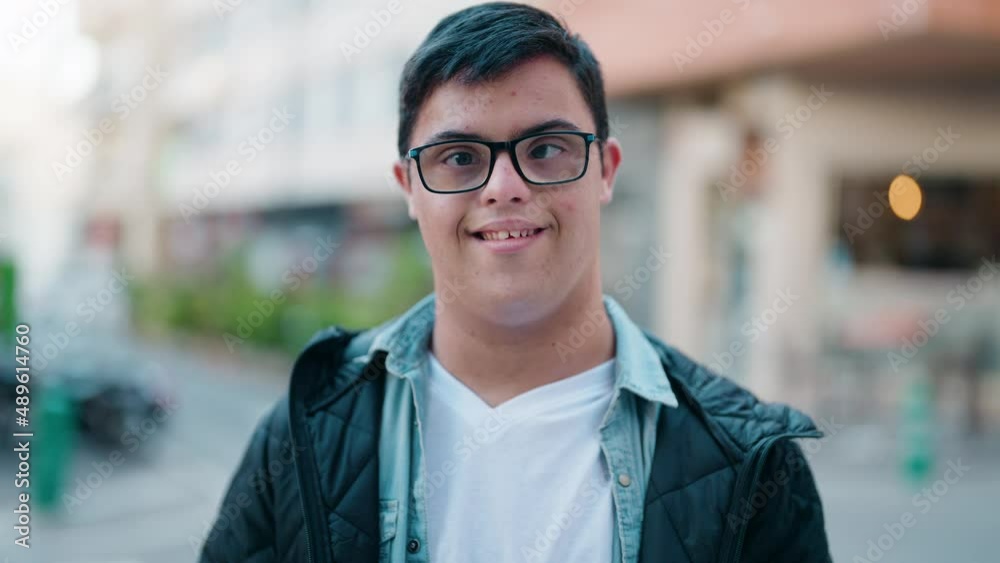 Down syndrome man smiling confident standing at street Down syndrome man smiling confident standing at street