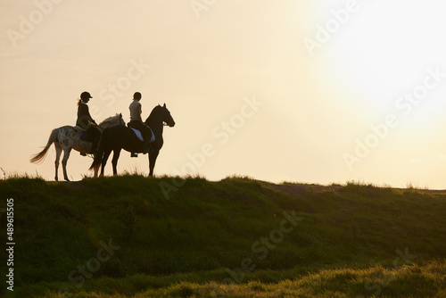 A horse is the projection of peoples dreams. Shot of two unrecognizable women riding their horses outside on a field. © Nina Lawrenson/peopleimages.com