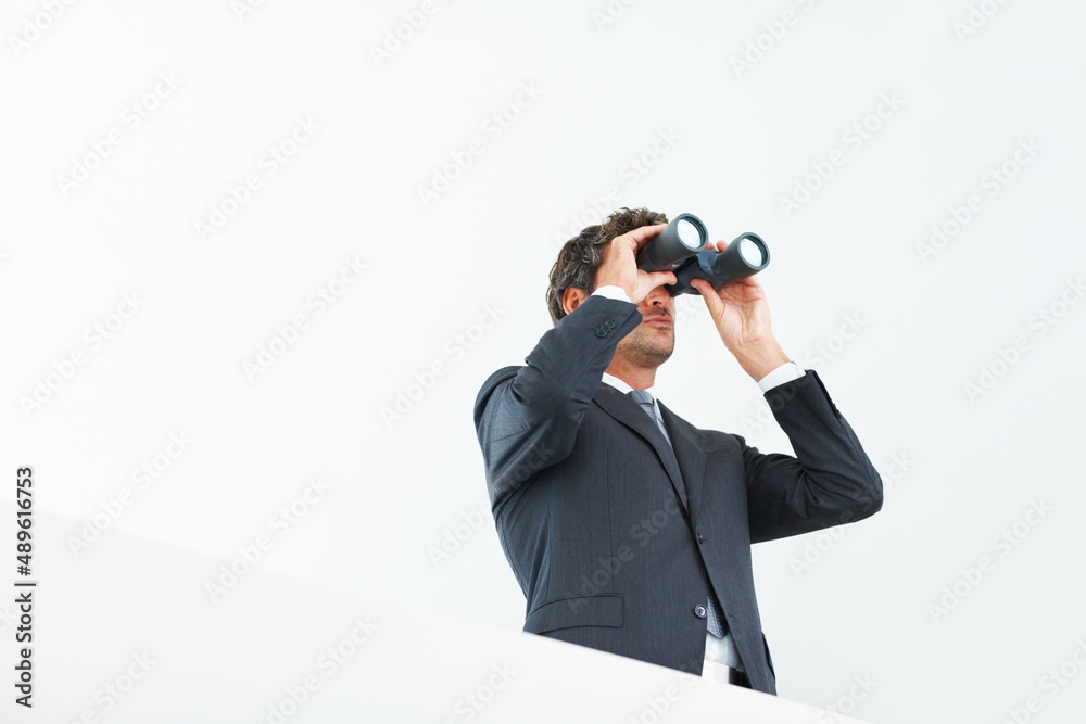 Visionary business man. Low angle view of handsome business man looking through binoculars. Visionary business man. Low angle view of handsome business man looking through binoculars.