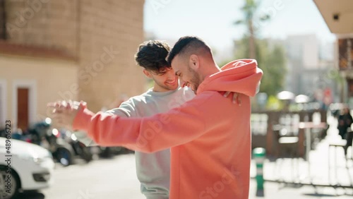 Young hispanic couple smiling confident dancing at street