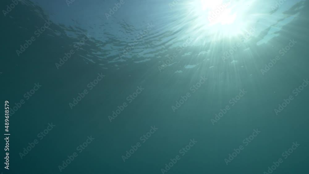 sun ray and sun beam scenery underwater waves on surface of water slow ocean scenery backgrounds sun ray and sun beam scenery underwater waves on surface of water slow ocean scenery backgrounds