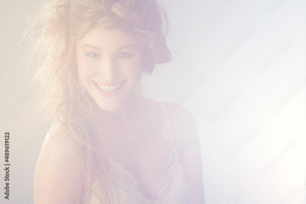 Dream-like beauty. Portrait of an attractive young woman - lens flare.