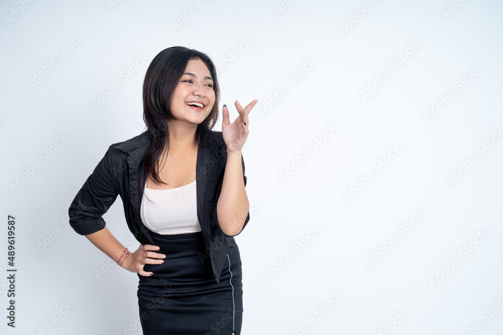 young woman standing with hands on waist and finger pointing young woman standing with hands on waist and finger pointing