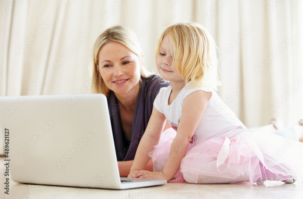 Shes pretty techno-savvy for such a young kid. Shot of a mother and daughter bonding while surfing the internet together.