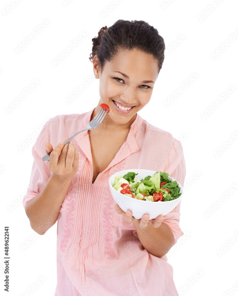 Making the healthy choice and having a salad. Young womanl smiling while eating a fresh green salad. Making the healthy choice and having a salad. Young womanl smiling while eating a fresh green salad.