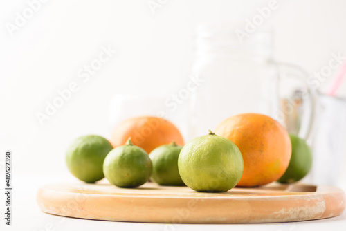 Fresh lime fruit from local market on white background is prepared as an ingredient in refreshing summer drinks.