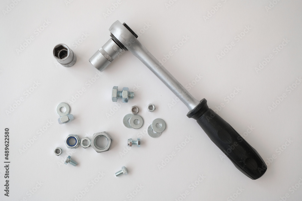 Nuts, screws, bolts are on a white background. Construction tools and parts. Nuts, screws, bolts are on a white background. Construction tools and parts.