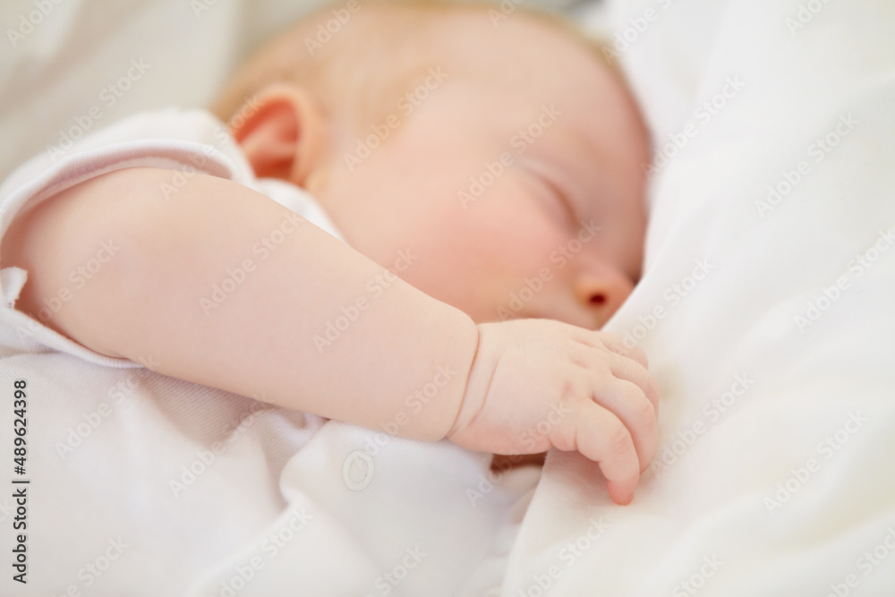 Baby in dreamland. A baby girl fast asleep in between her white pillows. Baby in dreamland. A baby girl fast asleep in between her white pillows.