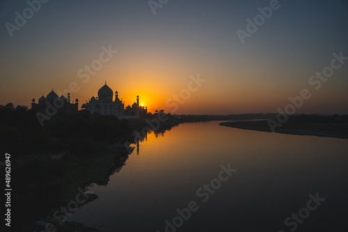 A wide angled view of Taj Mahal in Agra captured with Yamuna River beside. Taj Mahal during sunset in agra. © Yogendra