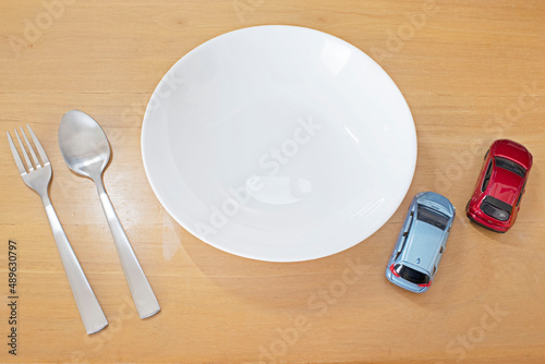 Wallpaper Mural a plate and a fork and a spoon and many cars on the table Torontodigital.ca