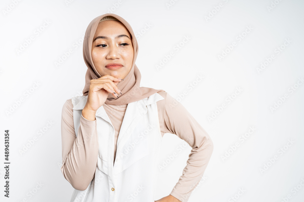 cynical asian muslim woman expression while standing over white cynical asian muslim woman expression while standing over white