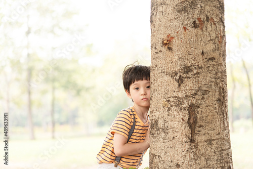 Young little boy stands alone on sunset time. Silhouette of boy, concept of lonely, sad, and scared.