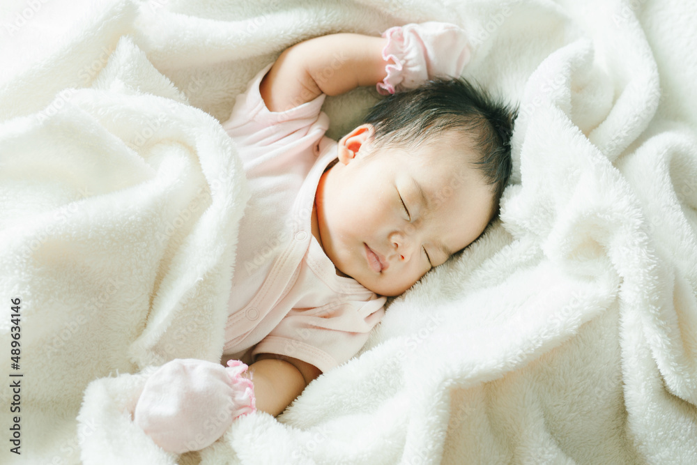 Portrait of Asian newborn or baby girl sleeping on bed New born kid concept. Portrait of Asian newborn or baby girl sleeping on bed New born kid concept.