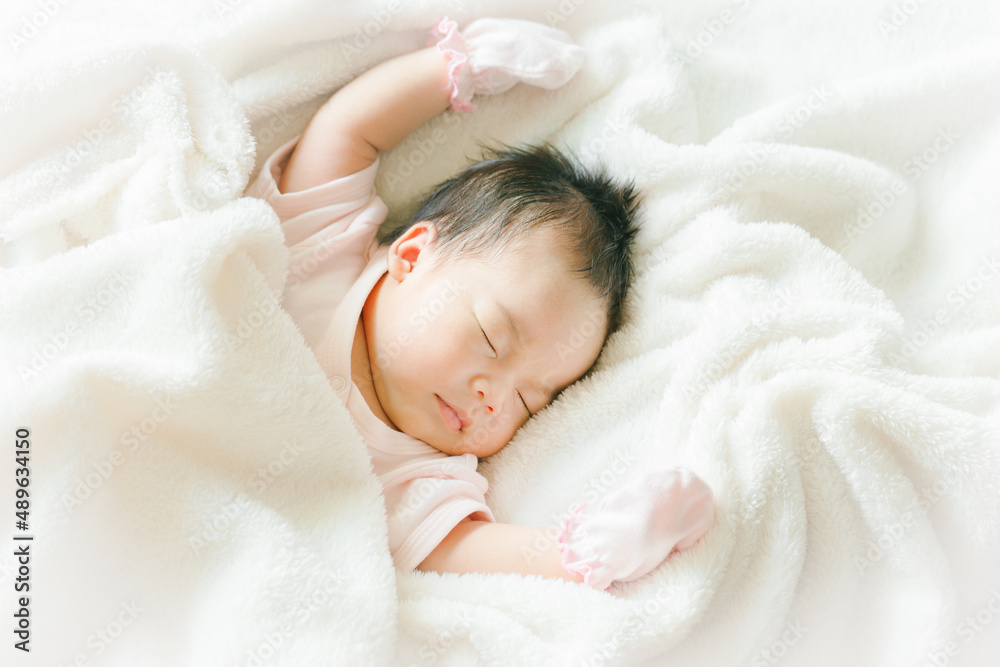 Portrait of Asian newborn or baby girl sleeping on bed New born kid concept. Portrait of Asian newborn or baby girl sleeping on bed New born kid concept.