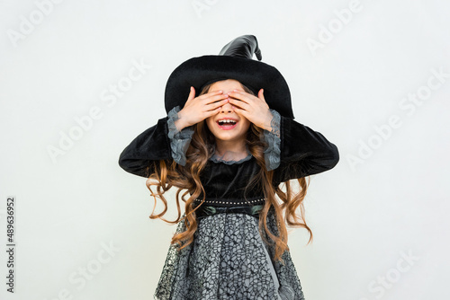 Fotografiet A joyful and surprised girl in a witch's outfit