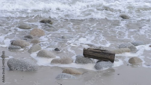 Driftwood waves surf rocks and ocean seascape