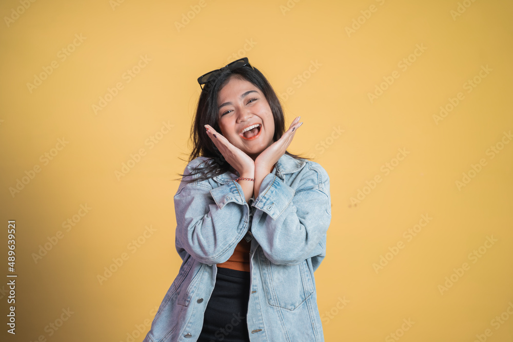 Excited young woman opening two palms while smiling Excited young woman opening two palms while smiling