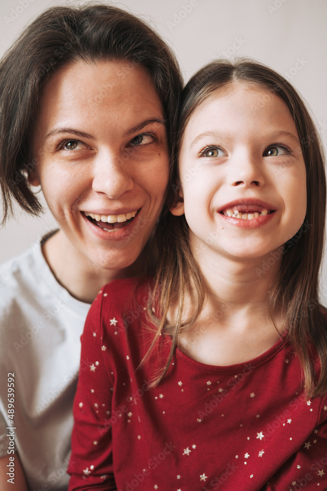 Close up portrait of happy Mom and daughter together at the home