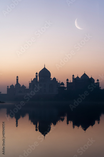 Taj Mahal captured early in the morning with a half moon on the top of it. Taj Mahal is the eighth wonder of the world situated in agra.