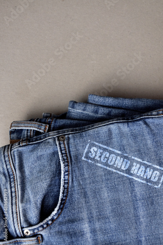 A stack of worn clothes with the inscription: second hand
