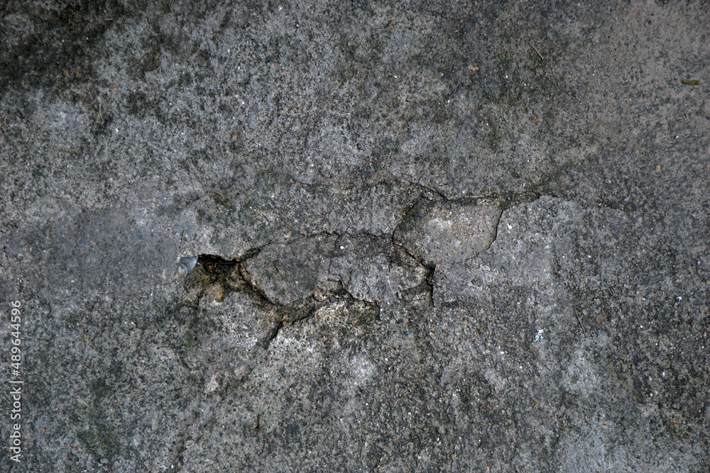 cracked cement covered with gray cement surface as background for design cracked cement covered with gray cement surface as background for design