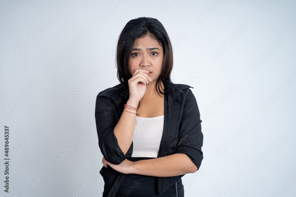 Young woman worried with bite finger gesture Young woman worried with bite finger gesture