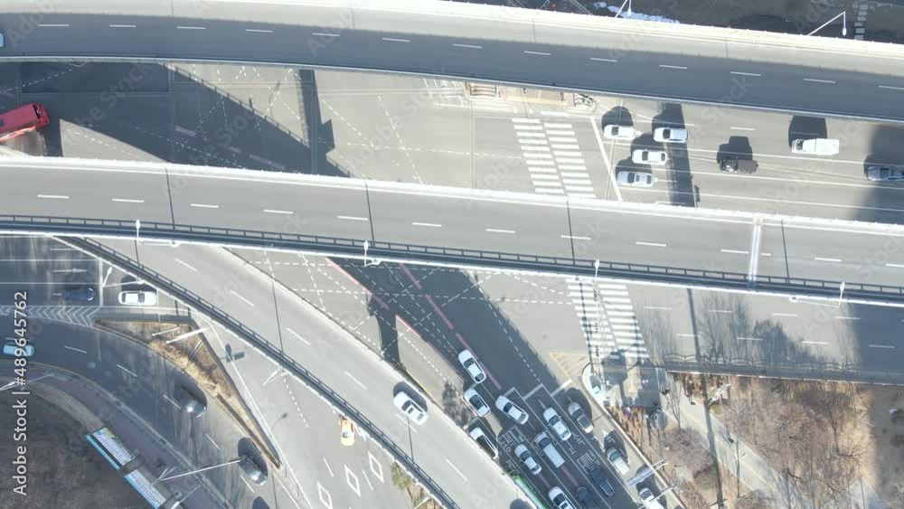 Cars drive along traffic intersection in city, aerial view. Cars drive along traffic intersection in city, aerial view.