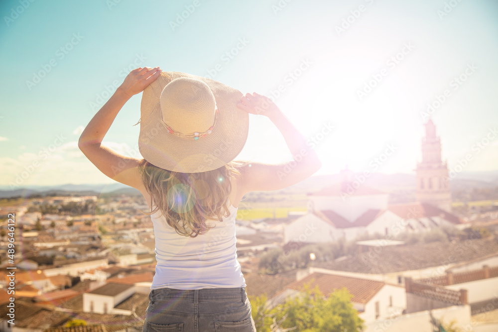 woman standing on balcony looking at beautiful city view panoramic- Spain