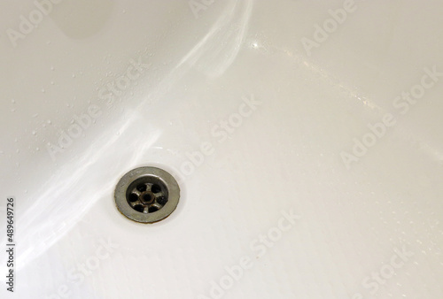 sewer drain in a white bath
