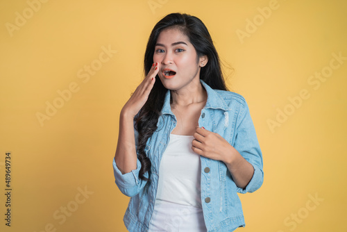 Young woman with shocked expression with hands covering mouth