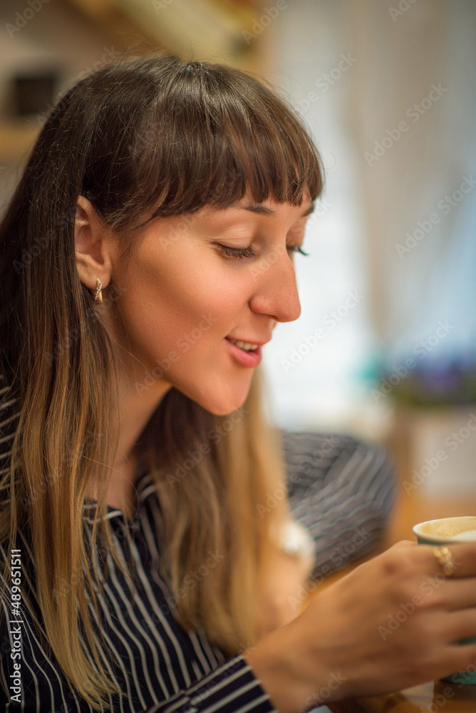 Portrait of a young beautiful blue-eyed girl in a cafe.
Portrait of a young beautiful blue-eyed girl in a cafe.