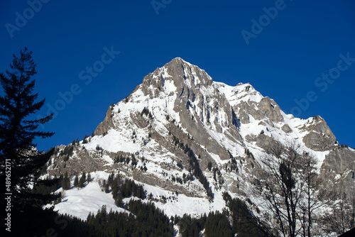 Aerial view of mountain panorama at the Swiss Alps seen from ski resort Engelberg, focus on background. Photo taken February 9th, 2022, Engelberg, Switzerland.