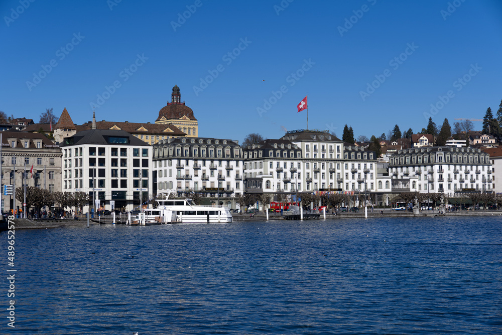 Cityscape of Luzern with lake Lucerne in the foreground on a sunny winter day. Photo taken February 9th, 2022, Lucerne, Switzerland.