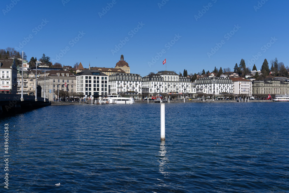 Fototapeta premium Cityscape of Luzern with lake Lucerne in the foreground on a sunny winter day. Photo taken February 9th, 2022, Lucerne, Switzerland.