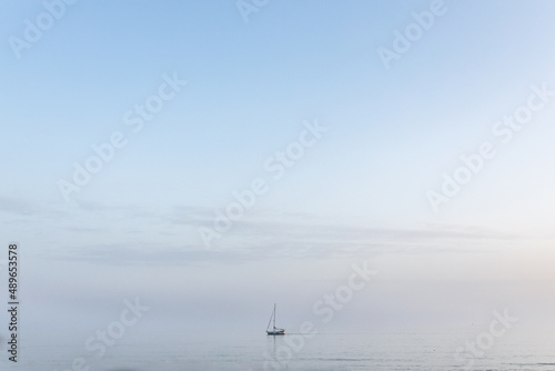 Lonely sailboat out on the ocean off the Mediterranean Sea in Sitges  Spain.
