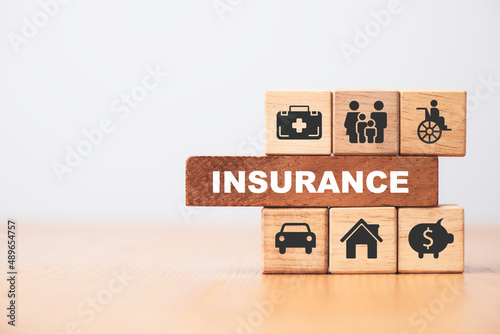 Insurance and assurance icon including family health real estate car and financial print screen on wooden cube bock for risk management concept.