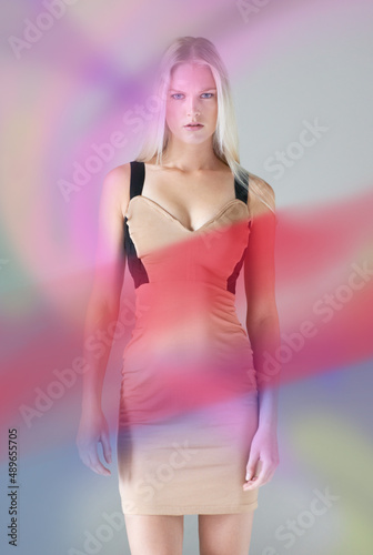 Color perfect. Portrait of an attractive young female wearing a dress with colours floating around her.