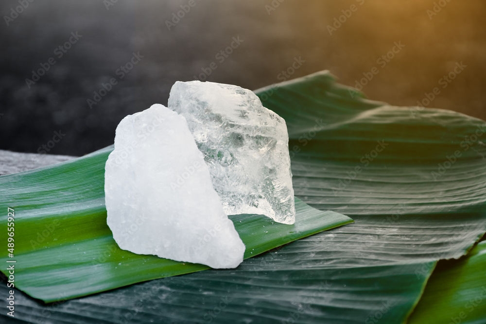 Transparent crystal alum stone or Potassium alum on banana leaf