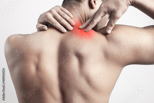 trapezius muscle pain, muscular man showing injury pan in shoulder muscle or levator muscle