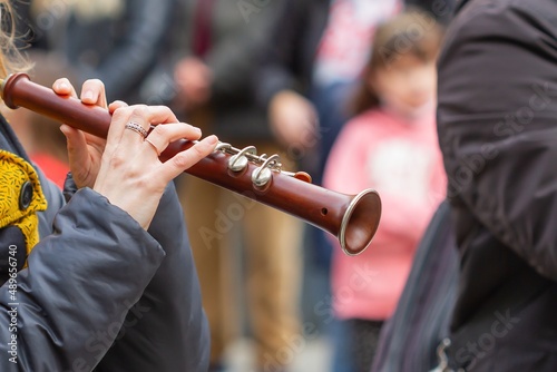 Unrecognizable musician playing the Gralla at a popular event in Barcelona (Spain), selective approach to the hand. photo