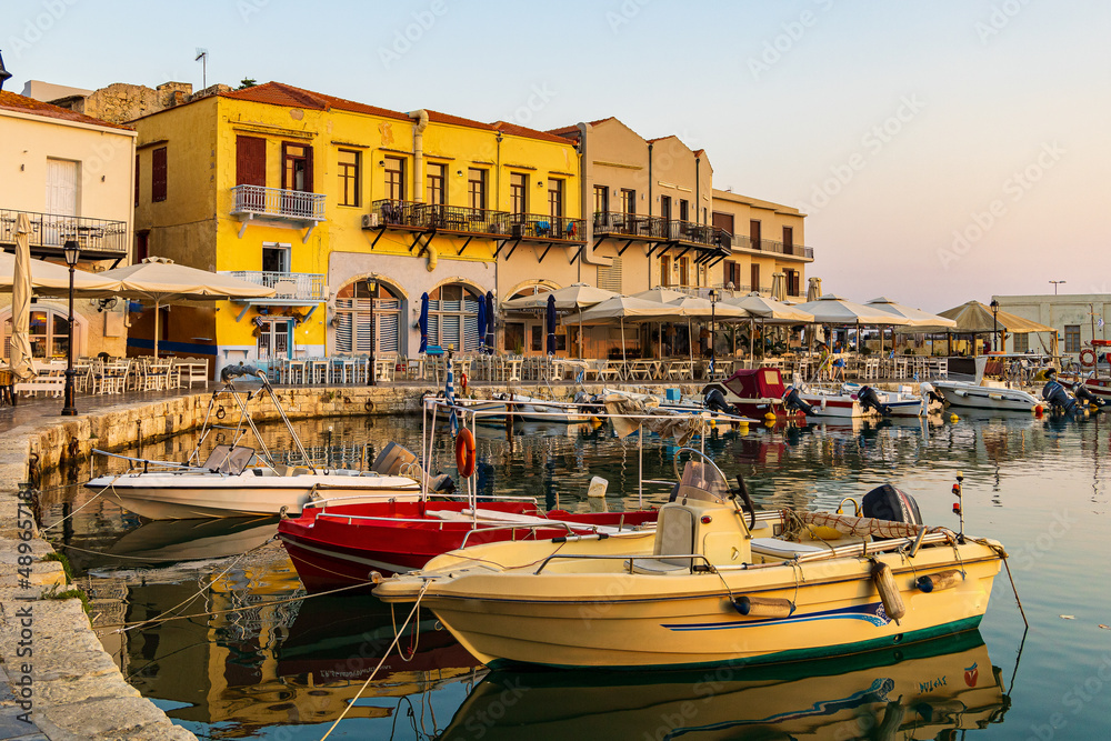 Beautiful and calm morning at the greek harbor of Rethymno with fisher boats in Crete, Greece