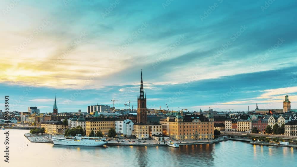 Stockholm, Sweden. Scenic View Of Stockholm Skyline At Summer Evening. Famous Popular Destination Scenic Place In Dusk Lights. Riddarholm Church In Day To Night Transition Time Lapse. Stockholm, Sweden. Scenic View Of Stockholm Skyline At Summer Evening. Famous Popular Destination Scenic Place In Dusk Lights. Riddarholm Church In Day To Night Transition Time Lapse.