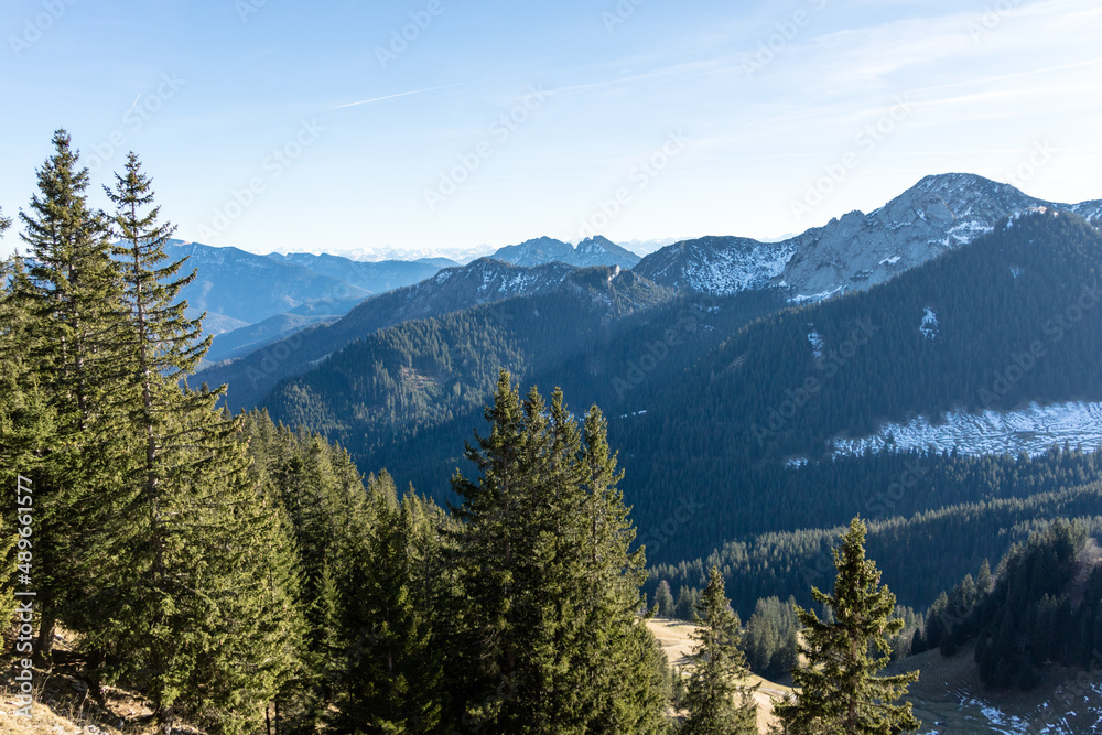 Patches of winter snow on high forested mountains Patches of winter snow on high forested mountains