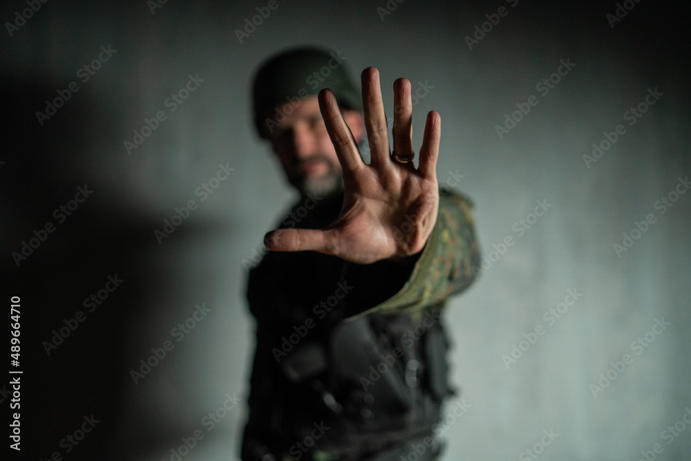 Frustrated military soldier showing hand to stop the war. Frustrated military soldier showing hand to stop the war.