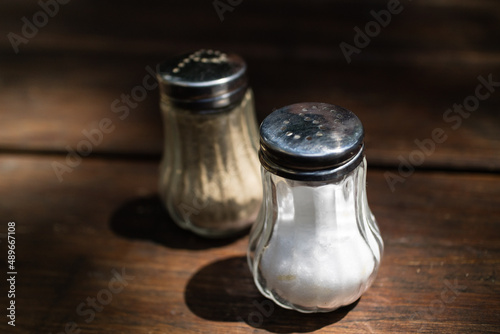 Salt and pepper dispensers on table